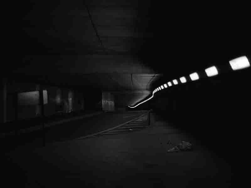 A black and white fine art photo illustrating a shadowy tunnel, capturing the essence of darkness and depth within.