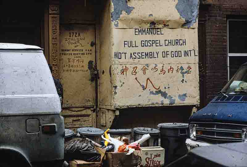 A van is parked in front of a graffiti-covered building, showcasing urban art and vibrant street culture.