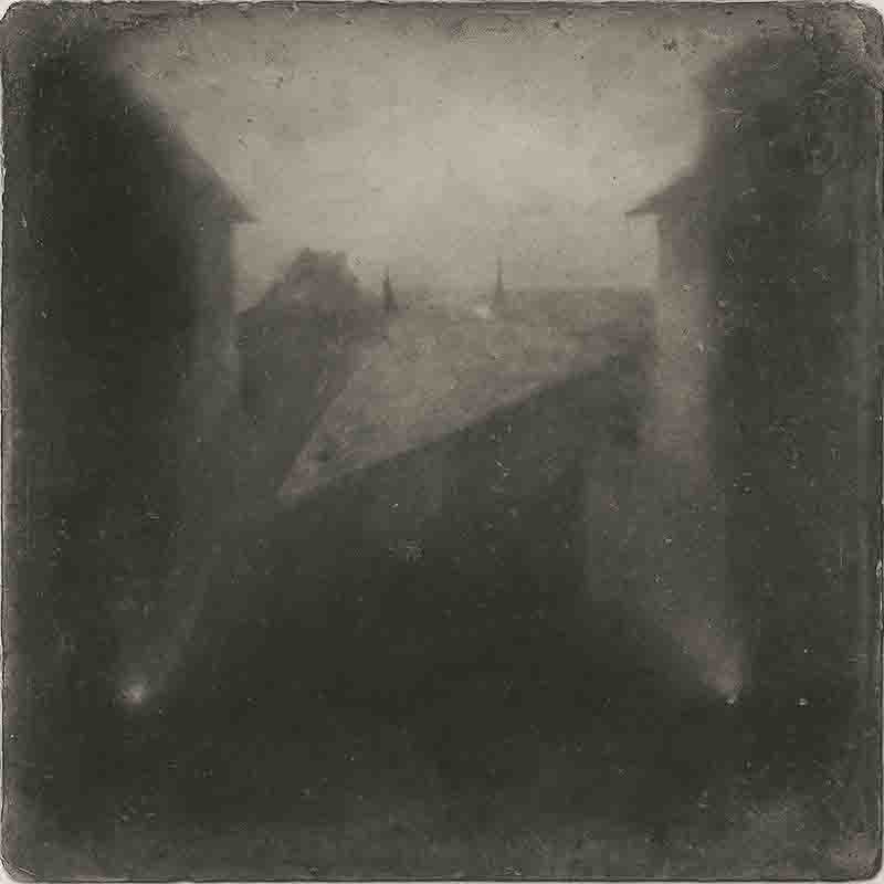 View from the Window at Le Gras. The image, created using heliography, shows buildings and trees on his estate in Saint-Loup-de-Varennes.